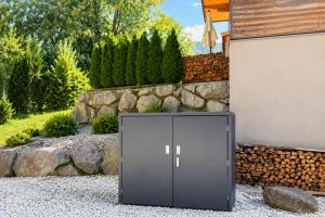 a metal locker sitting outside of a house at powderhome in Going am Wilden Kaiser