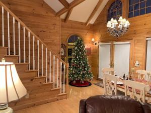 a living room with a christmas tree and a staircase at Buena Vista in Todd