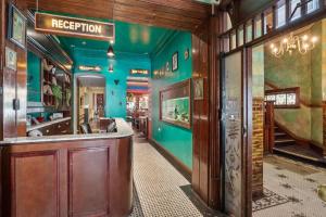a bar in a room with blue walls at Hotel Harry, an Ascend Collection Hotel in Sydney