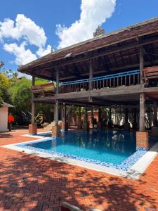 a swimming pool in front of a building at Cozy Paradise in Battambang