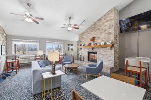 a living room with furniture and a fireplace at AmericInn by Wyndham White Bear Lake St. Paul in White Bear Lake