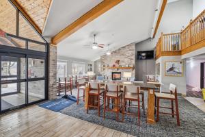 a dining room and living room with a table and chairs at AmericInn by Wyndham White Bear Lake St. Paul in White Bear Lake