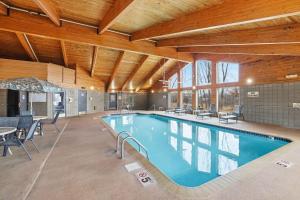 a large swimming pool in a large room with a table and chairs at AmericInn by Wyndham White Bear Lake St. Paul in White Bear Lake +62 photos