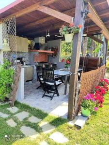 an outdoor patio with a table and a kitchen at Thea apartments 2 in Platamonas
