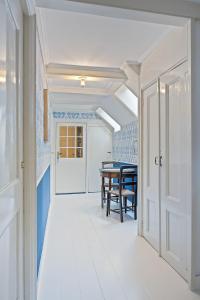 a hallway with a table and a dining room at Gentle in Bolsward