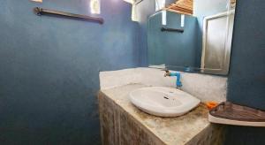 a bathroom with a white sink and a mirror at Longbeach Kohphayam in Ko Phayam