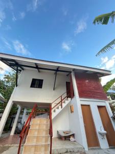 a small house with a red roof at Latitude 10 Siargao in General Luna