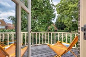 a balcony with two chairs on a deck at Gentle in Bolsward