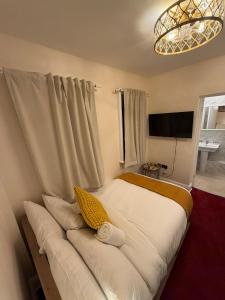 a bedroom with a bed with a yellow and white pillow at Milverton Court by OYO in Manchester