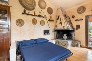 a bedroom with a bed and a fireplace at Villa Anna con giardino in Flussio