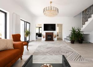 a living room with a couch and a tv at Grey House in Bucharest