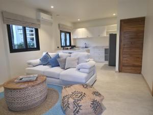 a living room with a white couch and a table at Casa By The Sea in Bangrak Beach