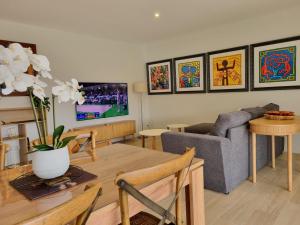 a living room with a table and a couch at Bernard in Soustons