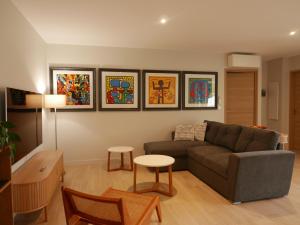 a living room with a couch and a table at Bernard in Soustons +17 photos