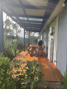 a patio with a table and chairs on a house at Prom Coast Residence in Fish Creek