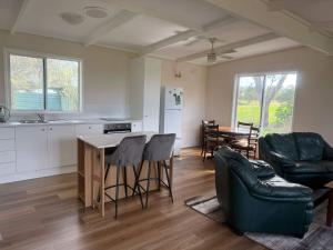 a kitchen and living room with a table and chairs at Prom Coast Residence in Fish Creek