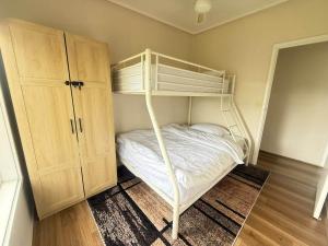 a bedroom with a bunk bed and a cabinet at Prom Coast Residence in Fish Creek
