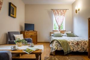 a bedroom with two beds and a window at Dworek Biebrzański in Augustów