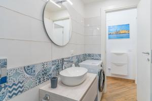a bathroom with a sink and a mirror at Casa Mare Vecchio in Avola +16 photos