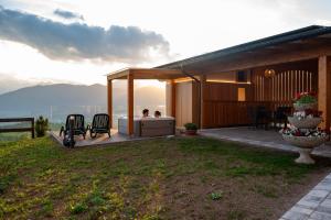 a house with a deck with a view of the ocean at Albergo Bucaneve in Malosco +44 photos