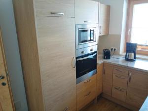 a kitchen with a stove and a microwave at Stapfgut in Rauris