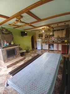 a living room with a stone fireplace and a table at Садиба Сонячний дім in Pilipets