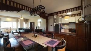 a kitchen and living room with a table and chairs at Boudha Breeze Suites 3bhk in Kathmandu