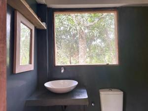 a bathroom with a bowl sink and a window at Koshi's Country Cottage Ella in Ella +60 photos