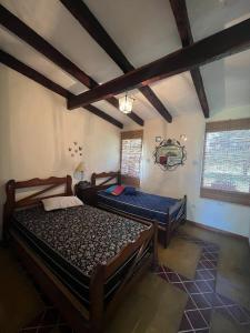a bedroom with two beds in a room at Rest has a name: Munay in Tafí del Valle