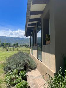 a building with a window with a potted plant on it at Rest has a name: Munay in Tafí del Valle +10 photos