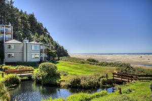 a house on the side of the beach with a river at Little Creek Cove Beach Resort in Newport