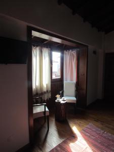 a living room with a chair and a window at Amazon Petite Palace in Selçuk