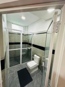 a bathroom with a toilet and a glass shower at Peak Blooms Ella in Ella +34 photos