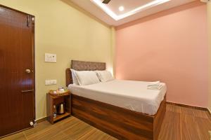 a small room with a bed and a door at La Casa d'Auroville in Auroville