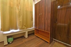 a bathroom with a shower and a wooden cabinet at La Casa d'Auroville in Auroville