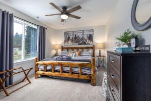 a bedroom with a wooden bed and a ceiling fan at Airport Place: 4 bedrooms, AC, Grill in Packwood