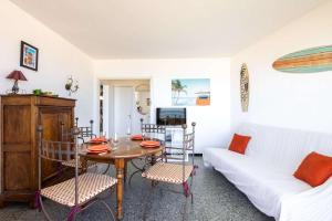 a living room with a table and a white couch at Valras'Loc - Evasion Marine in Valras-Plage +7 photos