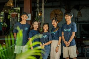 a group of people wearing blue shirts posing for a picture at Divine Divers Gili Meno in Gili Meno +245 photos