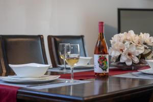 a bottle of wine and a glass on a table at KnoxPeace BnB in Kelowna +25 photos