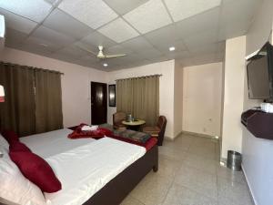 a bedroom with a large bed and a tv at Sheetal Resort and Restaurant in Rudraprayāg