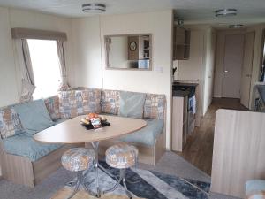 a living room with a couch and a table at 16 Vale Park in Fishguard