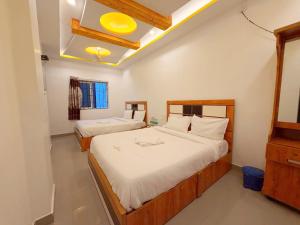 a bedroom with two beds in a room at EESHA Beach View Stay - Near Temple and Beach in Rāmeswaram