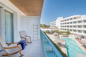 a balcony with chairs and a swimming pool at Inturotel Cala Esmeralda Beach Hotel & Spa - Adults Only in Cala d´Or
