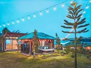 a house with a christmas tree in the yard at RMB's Downton Place in Tagaytay