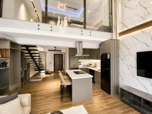 a kitchen and living room with a staircase and a dining room at Loft One Bedroom with Shared Private Pool in Aglantzia
