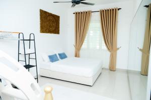 a white room with a bed and a ladder at Aisya homestay jerteh in Jertih