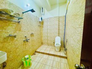 a bathroom with a shower with a toilet in it at Hotel Keptown in Patna +11 photos
