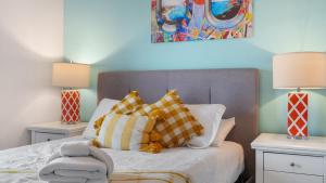 a bedroom with a bed with pillows and two lamps at Laketown Wharf 809 in Panama City Beach