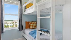 a bedroom with bunk beds and a balcony at Laketown Wharf 809 in Panama City Beach