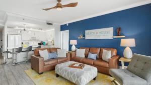 a living room with brown furniture and a blue wall at Laketown Wharf 809 in Panama City Beach +42 photos